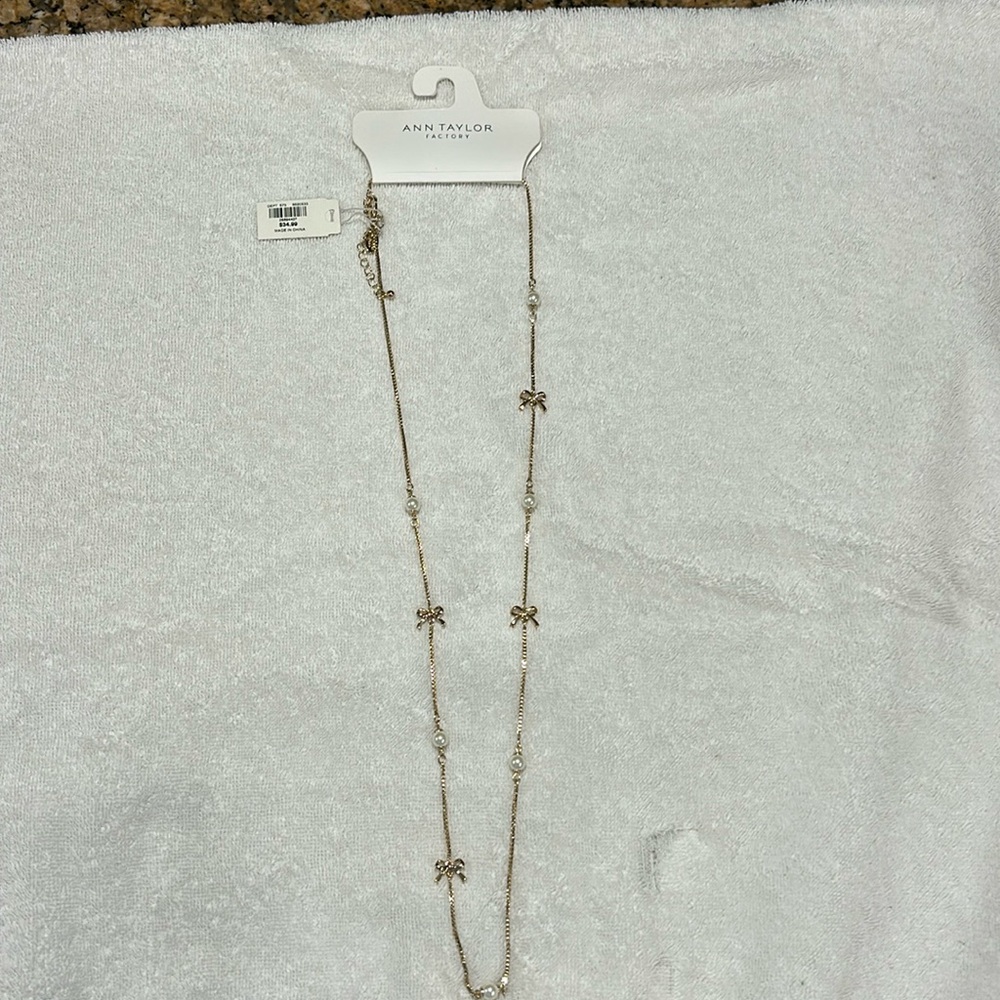 Gold now and pearl necklace